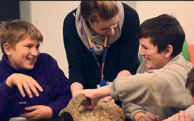 Staff and children handling collections