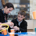 Staff and student making a balance scale