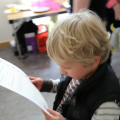 Child looking at his Arts Award Certificate 