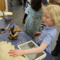 Child touching bear paw 