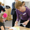 Staff member instructing a child