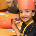 Young girl making a paper crown 