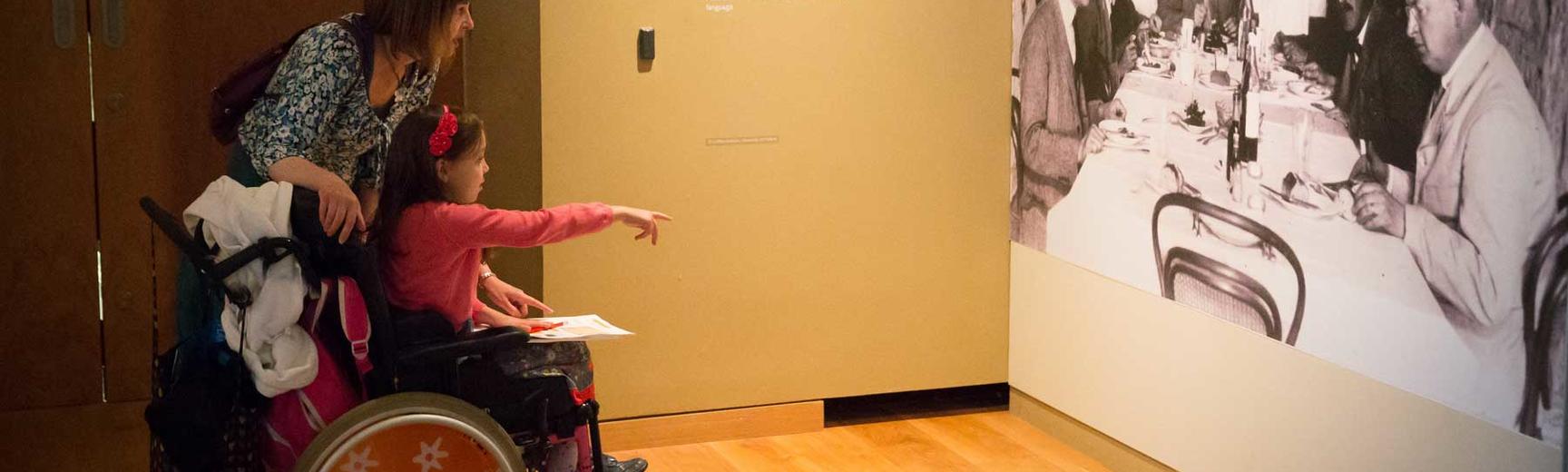 A wheelchair user visiting an exhibition at the Ashmolean