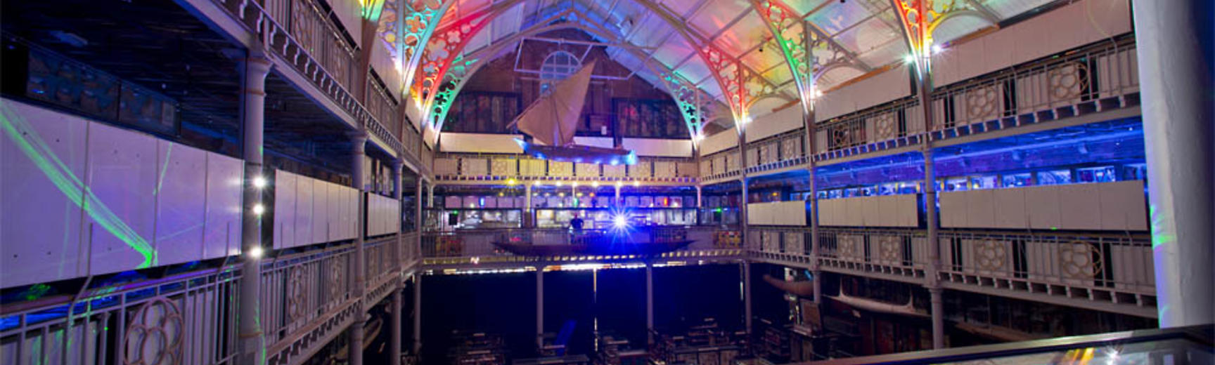 Overlooking museum main court showing colourfully lit ceiling and display cabinets