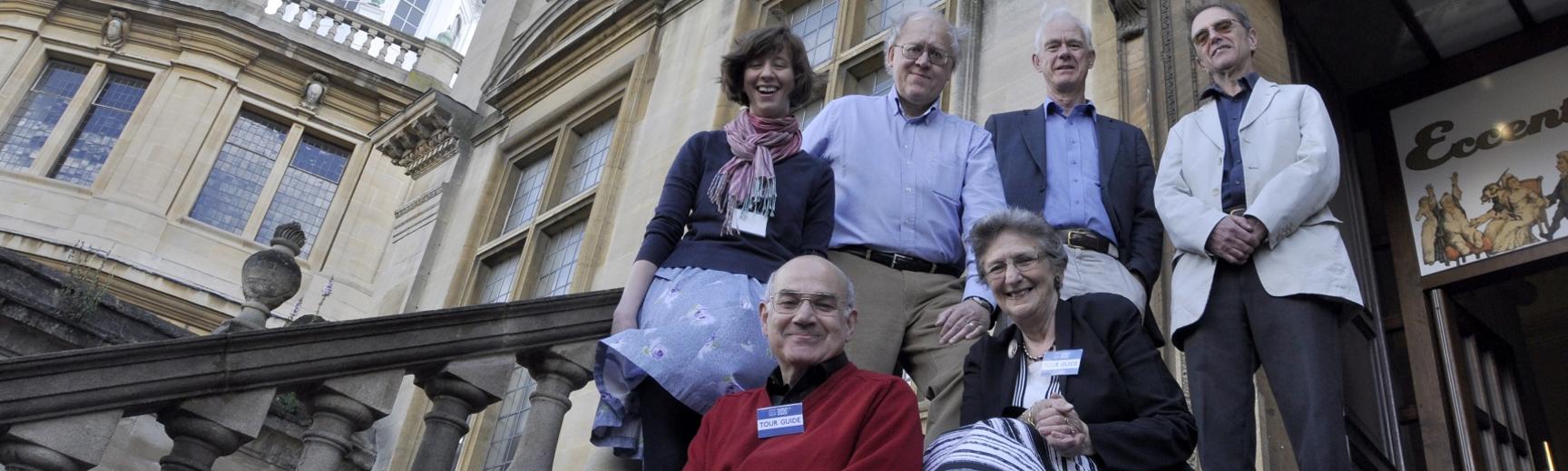 Volunteer tour guides posing on the steps of the History of Science Museum