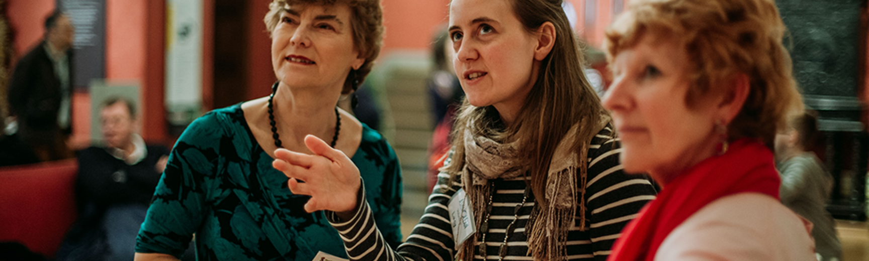 Volunteer talking to two adult visitors during an Ashmolean tour