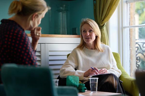 Two women sat listening and talking