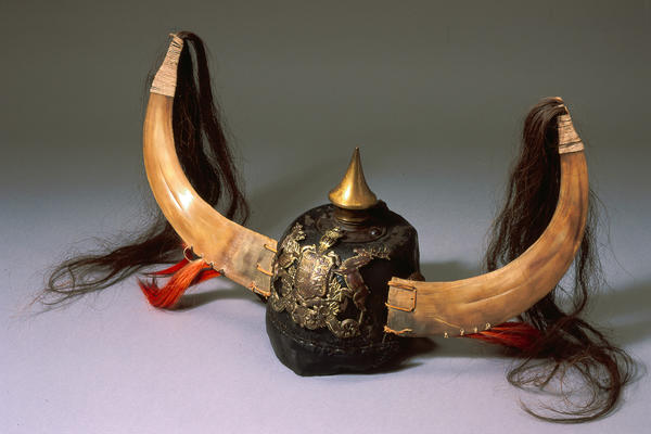 Dance hat made from old German military helmet, with horns and hair attached at Pitt Rivers Museum