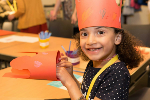 Young girl making a paper crown 