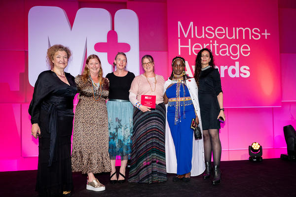 Members of the Maasai Living Cultures Project pose with award trophy. 
