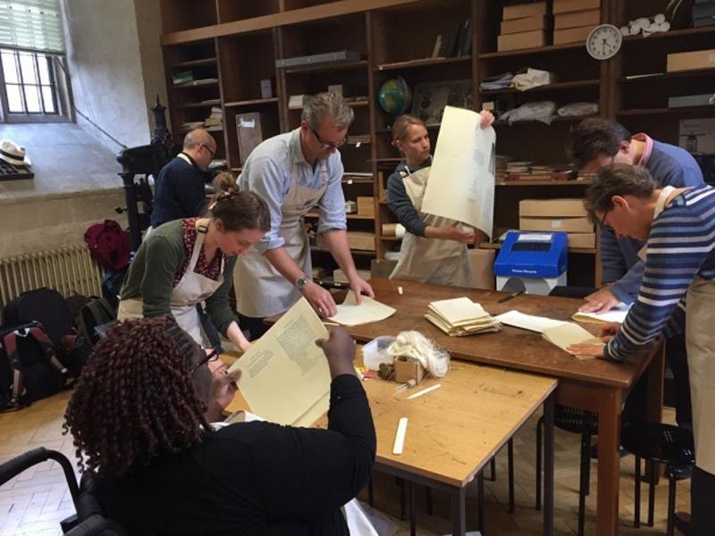 Members of the public engaging in printing press activity at the Bodleian Libraries