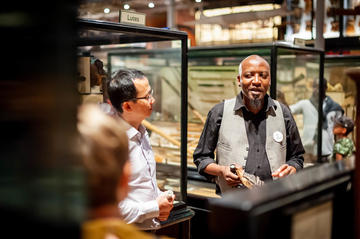 multaka oxford volunteer leading a tour with lots of people in the foreground at the pitt rivers museum