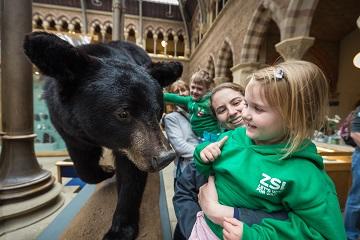 Children looking at black bear taxidermy