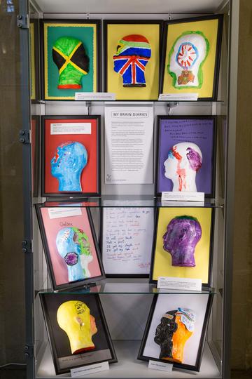 Artwork created by Brain Diaries participants Display of nine painted heads