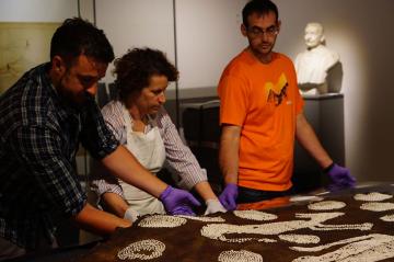 Ashmolean conservators working on Powhatan's Mantle, 2017 Three conservators working on an object in the museum