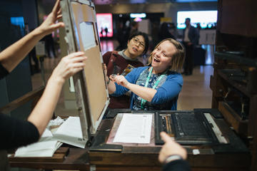 Participants enjoying the printing press