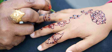 Applying henna tattoos at the Alice Celebrates Eid event in Oxford