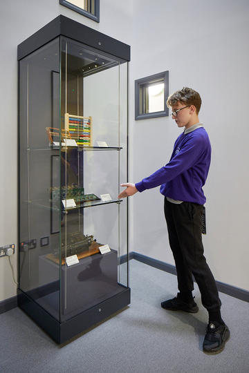Iffley Academy & HSM Display Case - Yacine presenting at unveiling 2 (c) Ian Wallman Boy pointing to museum display