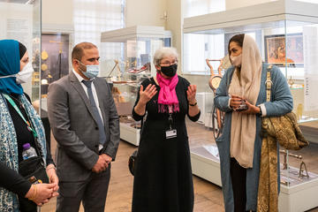 Princess Lamia standing with HSM museum staff and volunteers in the museum gallery