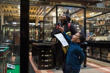 Happy young child and woman in Pitt Rivers Museum gallery