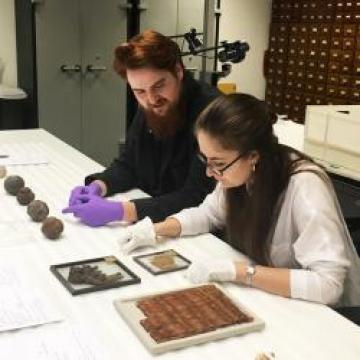 Artists Abigail Booth and Max Bainbridge working in the Pitt Rivers Museum