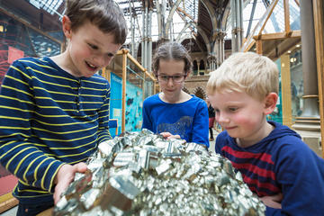 Children in museum with rock