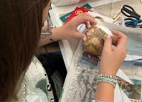 a person is working on a paper globe