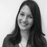 Black and white headshot of staff member Alex Amey, who has medium-length brunette hair. 