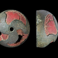 Bronze stud with curved triskele design filled with red enamel