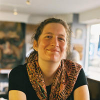 Image of a woman wearing a brown neck scarf