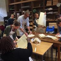 Members of the public engaging in printing press activity at the Bodleian Libraries