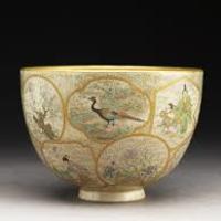 Cream Japanese tea bowl featuring images of birds. 